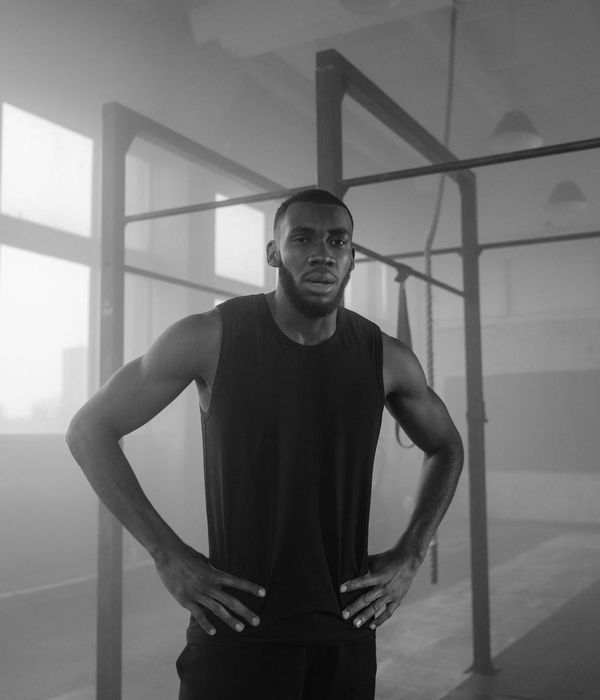 Man performing athletic strength training in a modern studio gym.